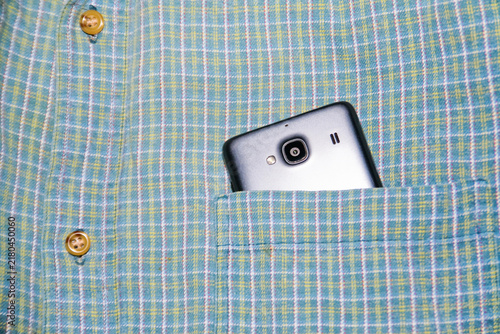 Close up of smartphone in plaid shirt pocket