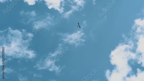 Light aircraft flying in the sky during a sunny day over open space