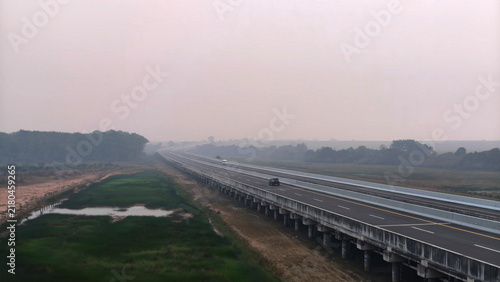 Fotografie toll road with fire smoke in the background