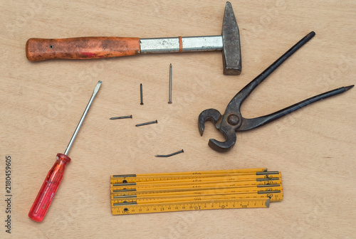 фотографія hammer, pliers, nails, screwdriver and folding rule