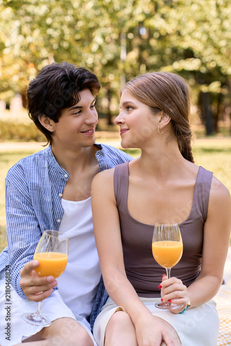 Quadro su tela A happy couple shares a romantic picnic in a lush green park under the sun