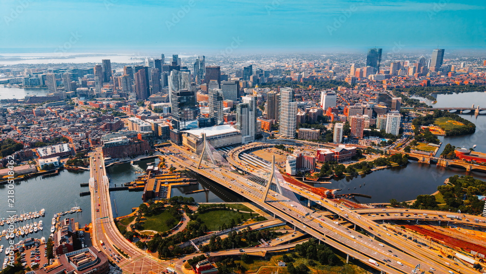 Obraz premium Aerial view of Zakim Bridge and highway interchange in Boston. A cable stayed bridge crosses river near road junction in Boston, USA.