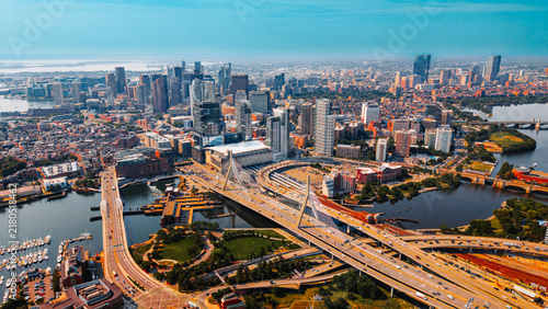 Aerial view of Zakim Bridge and highway interchange in Boston. A cable stayed bridge crosses river near road junction in Boston, USA.