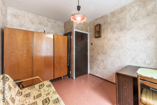 Retro Vintage Living Room With Floral Wallpaper, Wooden Wardrobe and Patterned Sofa
