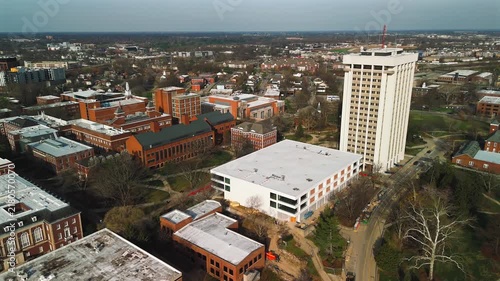 Backward aerial pullout from University of Kentucky campus over Lexington neighborhoods