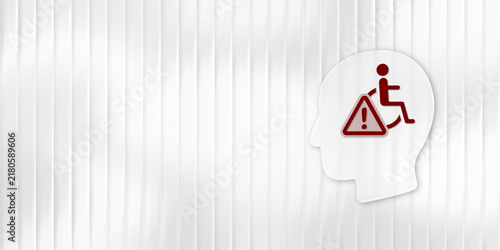 Conceptual graphic featuring a white human head silhouette with a wheelchair user icon and a hazard warning sign on a ribbed white background symbolizing accessibility challenges.