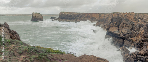 Waves crashing against rocky cliffs at Papoa in Peniche Portugal
