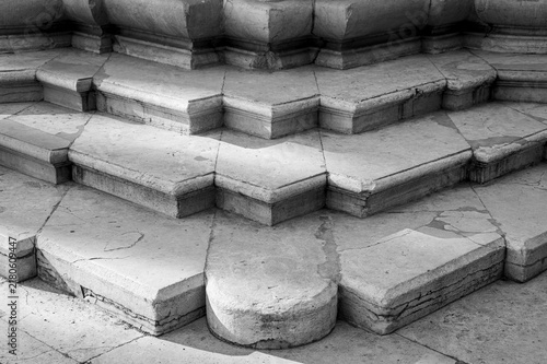 Weathered stone steps with geometric architectural details in black and white