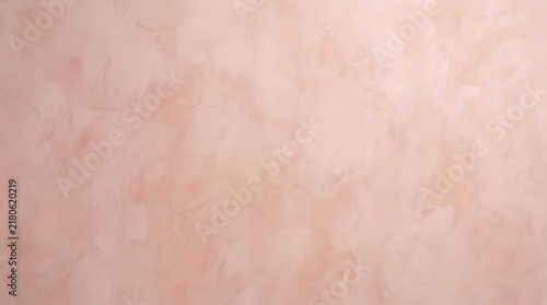Close-up view of a soft pink textured wall with a subtle, mottled finish, creating an elegant background.