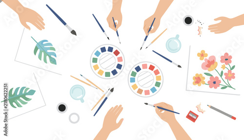 High angle view of multiple hands painting with watercolors using various brushes and palettes on several white papers.