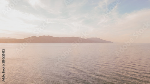 Bild auf Leinwand Serene coastal view of Crete at sunset with gentle waves lapping against the sho