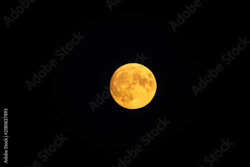 Yellow moon on a dark background at night on the island of Crete, Greece in summer