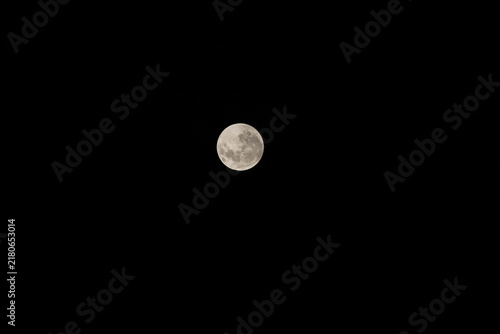 Fotografie Full Moon Glowing Brightly in Dark Black Night Sky