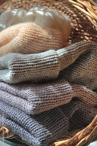 Cuadro en lienzo Stack of cozy knitted winter beanies and fluffy wool accessories neatly folded i