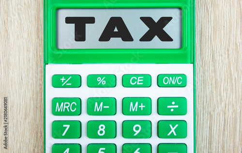 TAX a word, text on a calculator display. Taxation, financial law, tax payment, financial business concept, wallpaper.