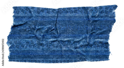 Fotografía Rectangular piece of textured blue denim fabric with frayed rough edges and wrin