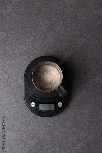 Canvas Print Overhead view of tangzhong in a silver cup on dark background, top view of tangz