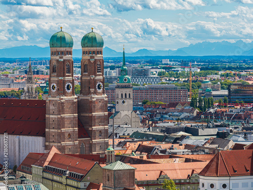 Skyline with Munichs Frauenkirche and the alps in the background