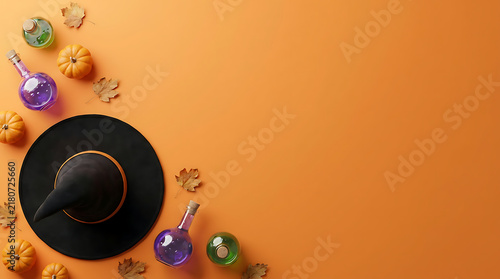 Halloween witch hat and magic potion bottles on orange background with copy space