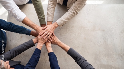 Collaborative business team stacking hands, diverse professional group unity and partnership, corporate success and teamwork concept