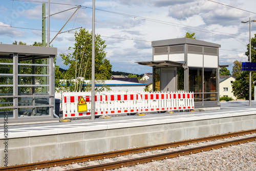 Railway Station Platform Under Construction with Safety Barriers and Elevator Shaft