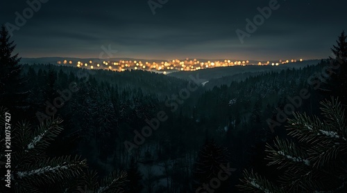 Dark emerald green winter forest landscape at night with glowing city lights in the distance, pine tree branches in foreground, atmospheric Christmas holiday background scenery