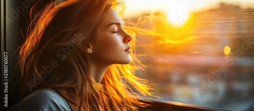 Serene Portrait of a Young Woman with Flowing Red Hair Basking in the Golden Hour Light of a Warm Sunset