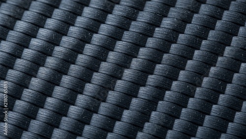 Black carbon fiber texture woven pattern surface with dark synthetic fiber structure close up view

