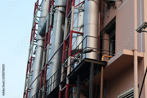 Принти на полотні Industrial factory exterior with metal ventilation pipes and red steel support s