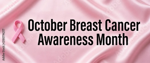 Pink satin background with pink ribbon for breast cancer awareness