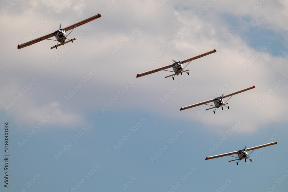 Fototapeta premium Group of ViS-3 KhAZ-30 ultralight ukrainian planes flying in group stunt on airshow in cloudy sky