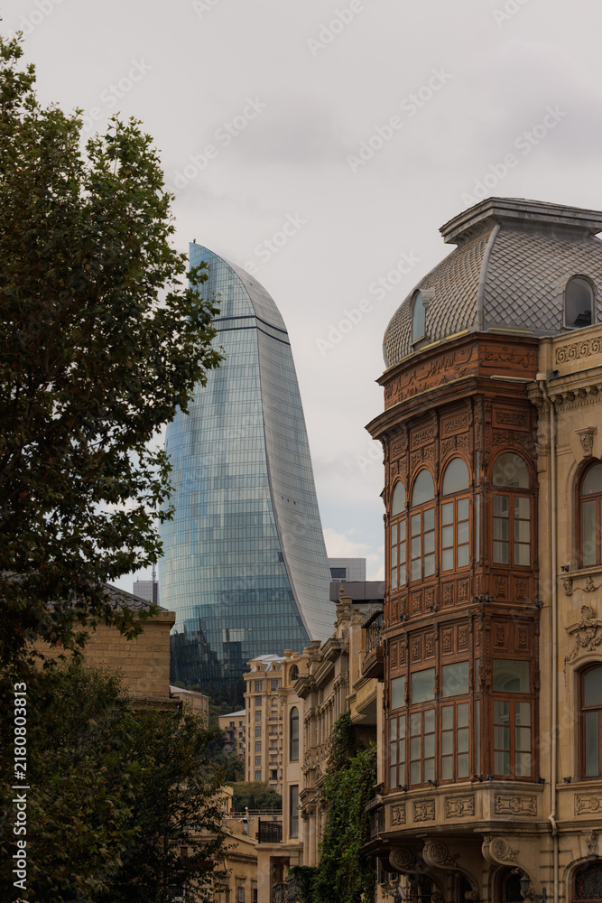 Obraz premium Modern architecture meets historical charm in Baku, showcasing unique buildings under a cloudy sky