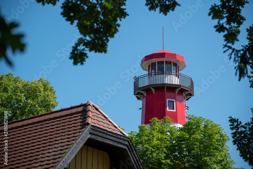 фотографія Newly painted red and white lighthouse in midday sunlight.