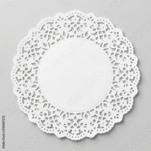 White paper doily with intricate lace pattern isolated on white background