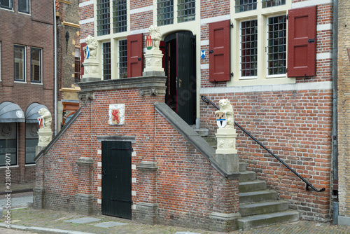 Quadro su tela Brick double staircase with stone lion sculptures leading to the main entrance of the historic 16th-century town hall in Oudewater, Netherlands