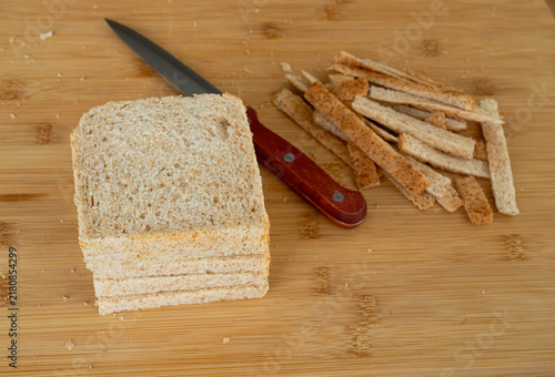 Bild auf Leinwand Cutting the crusts off, crustless bread for sandwiches closeup
