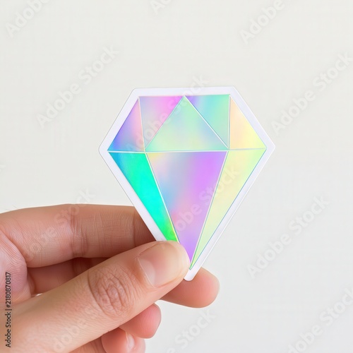 Hand holding holographic diamond sticker