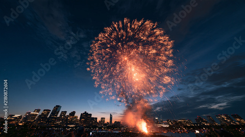 Bright Fireworks Exploding Over City Skyline at Night