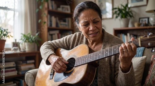 Older Woman Reclaiming Guitar Playing Skill in Living Room Candid