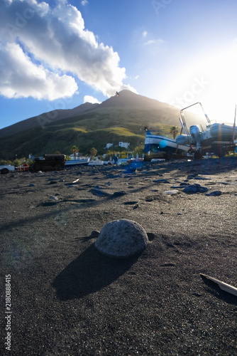 Black Sand Beach and Smoking Volcano in Stromboli, Italy