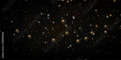 Sparkling gold and silver particles float and glitter against a deep black background, creating a luxurious and festive ambiance, perfect for celebrating special occasions or adding a touch of magic.