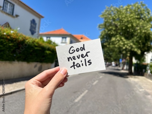 God never fails - hand with christian motivational note about faith, outdoors	