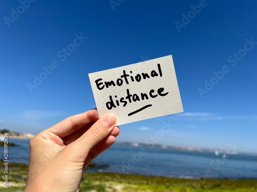 Emotional distance - hand with a psychology note, mental health and relationship concept