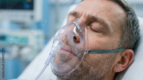 Realistic close-up of an exhausted patient wearing an oxygen mask during treatment in a modern hospital.