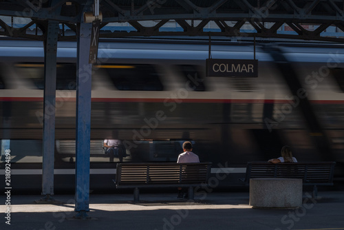 Train station with passengers waiting for train in Colmar in afternoon