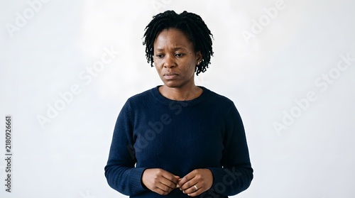 Young Black Woman Looking Thoughtful Against White Background.