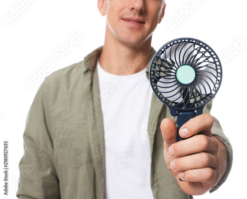 Obraz na płótnie Man with portable mini fan on white background, selective focus