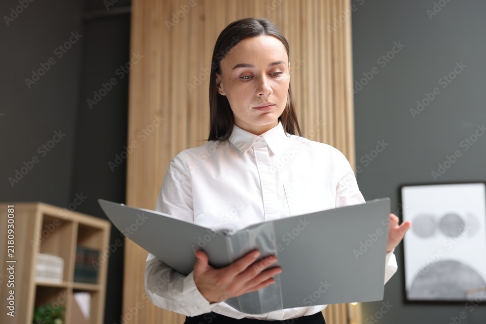 Naklejka premium Lawyer with folder in office, low angle view