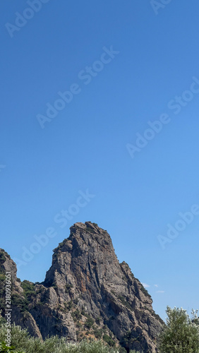 Majestic Rocky Mountain Peak Against Clear Blue Sky in Summer