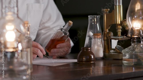 Victorian scientist writing information on a drug